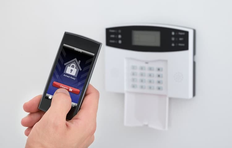 security alarm keypad with person disarming the system with remote controller